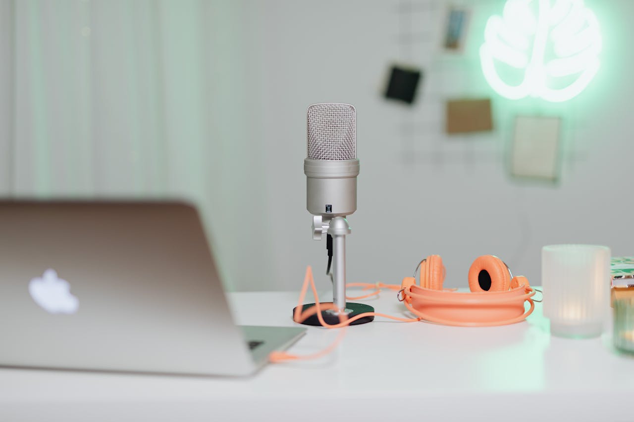 Mastering the First Impression: Your intriguing post title goes here A modern desk setup featuring a condenser microphone, laptop, and headphones in a stylish workspace.